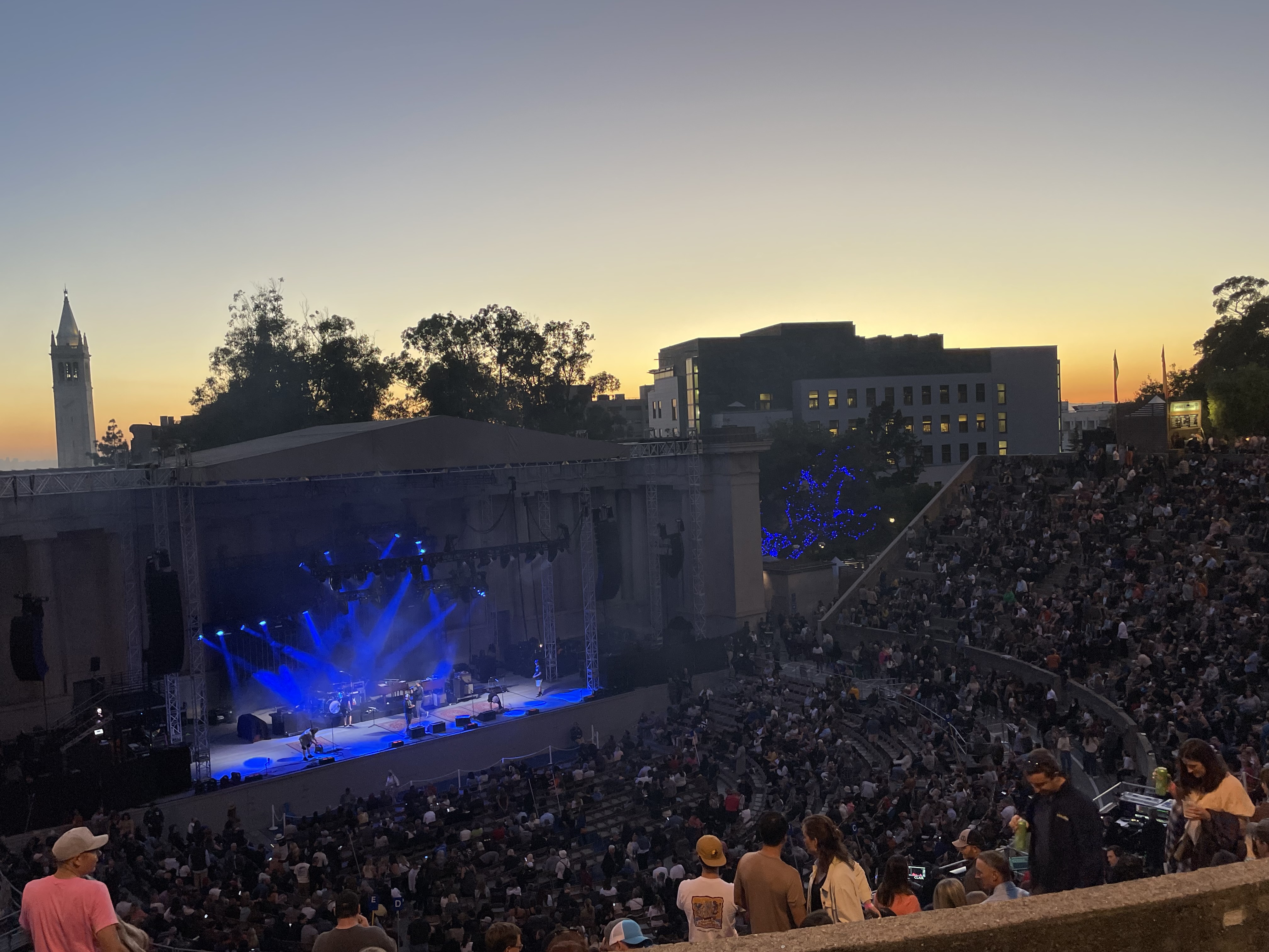 A packed amphitheatre at sunset — the Greek Theatre.